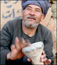 Drum maker demonstrates his wares, Luxor bazaar