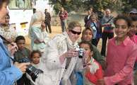 One of our travelers shows village kids their picture